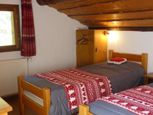 a bedroom with two beds and a window at Chalet Arêches-Beaufort, 5 pièces, 8 personnes - FR-1-342-246 in Beaufort