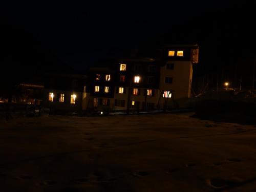 a building at night with its lights on at Apartment Turmzimmer in Langwies