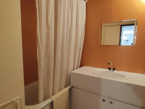 a bathroom with a sink and a shower curtain at Appartement Cauterets, 3 pièces, 6 personnes - FR-1-234-263 in Cauterets