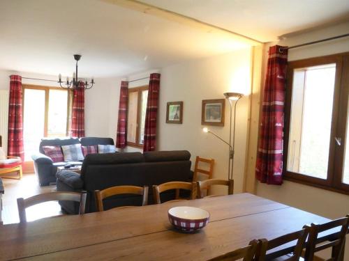 a living room with a table and a couch at Chalet 3* à Arêches, 100m², 8 pers, 4 ch, Pied des Pistes, Cheminée, Terrasse, Wifi - FR-1-342-246 in Beaufort