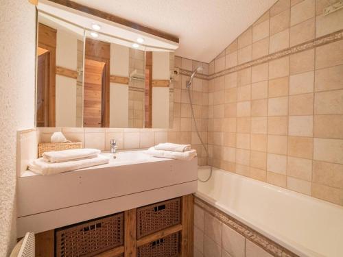 ein Badezimmer mit einem Waschbecken, einem Spiegel und einer Badewanne in der Unterkunft Appartement Valmorel, 3 pièces, 4 personnes - FR-1-291-871 in Valmorel