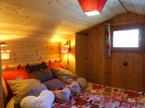 a living room with a couch with teddy bears on it at Chalet Hauteluce, 2 pièces, 3 personnes - FR-1-342-263 in Hauteluce