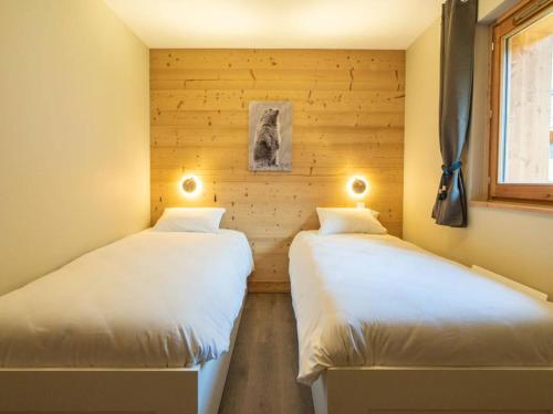 2 Einzelbetten in einem Zimmer mit Holzwänden in der Unterkunft Duplex 4 pièces avec balcon et parking, 6 pers. - Les Avanchers-Valmorel - FR-1-291-872 in Valmorel