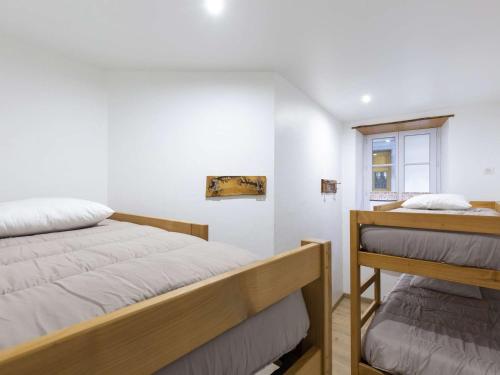 a bedroom with two beds and a window at Appartement Cauterets, 3 pièces, 6 personnes - FR-1-401-230 in Cauterets