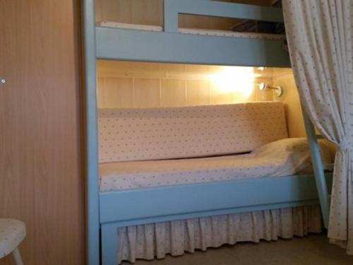 a bunk bed with a blue bunk bed in a room at Studio ski, 4 pers, parking gratuit, proche pistes - FR-1-602-97 in Arette