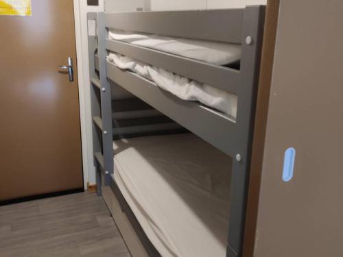 a bunk bed in a room with a closet at Studio Cauterets, 1 pièce, 4 personnes - FR-1-234-272 in Cauterets