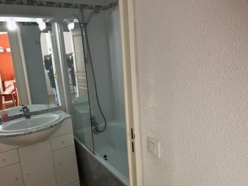 ラ・モンジーにあるAppartement cosy 4 pers. avec terrasse, piscine, fitness et parking - À 300m des pistes - FR-1-404-336のシャワー、洗面台、鏡を備えたバスルーム