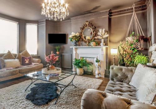 a living room with a couch and a table at KIRA Beach House, Hove Beach in Hove
