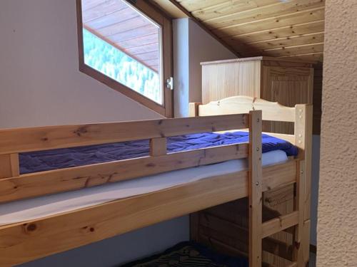 a bedroom with two bunk beds and a window at Appartement Saint-Jean-d'Aulps, 2 pièces, 6 personnes - FR-1-573-58 in Saint-Jean-d'Aulps