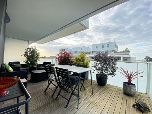 a patio with a table and chairs on a balcony at Appartement La Baule, 1 pièce, 4 personnes - FR-1-245-162 in La Baule