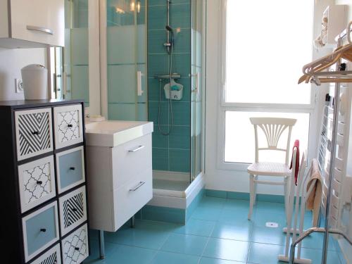 a bathroom with a sink and a shower and a chair at Appartement La Baule, 1 pièce, 4 personnes - FR-1-245-162 in La Baule