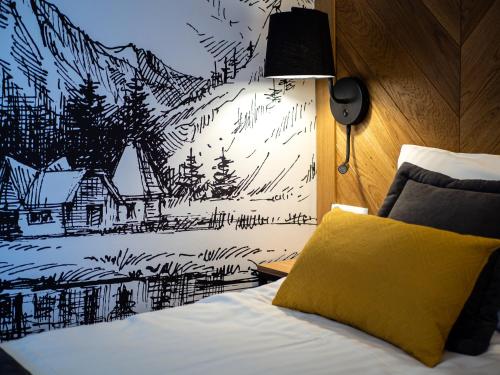 a bedroom with a bed with a mountain mural on the wall at Willa Roztoka & SPA - idealne miejsce dla Twojej rodziny in Bukowina Tatrzańska