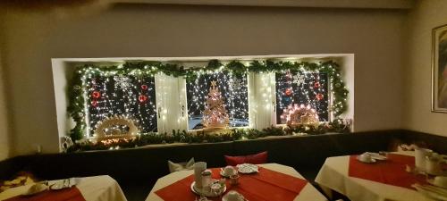 a restaurant with christmas lights in a window at BB City Hotel in Böblingen