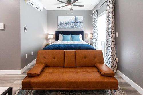 a bedroom with a couch in front of a bed at Professionals-Restaurants-FastWiFi-A C-Desk- Pets in San Diego