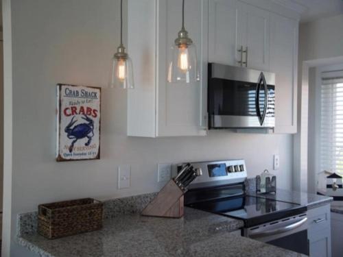 a kitchen with a counter top and a microwave at A Beach Dream condo in Carolina Beach