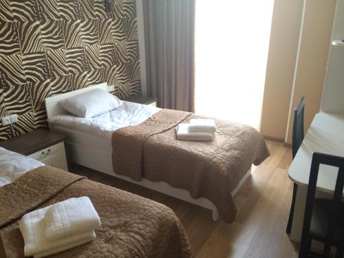 a hotel room with two beds and a window at Renaissance Hotel Tbilisi in Tbilisi City