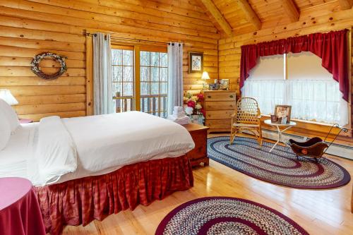 a bedroom with a bed in a log cabin at 262 Ghia Farm Road in Ludlow