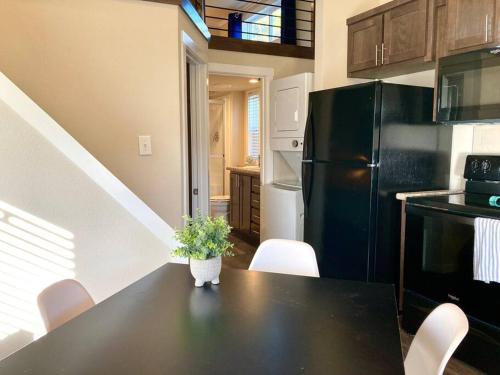 a kitchen with a black table and a black refrigerator at Cozy Tiny Home in the Hills in Fischer