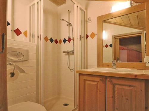 a bathroom with a shower and a sink and a mirror at Appartement Montvalezan-La Rosière, 3 pièces, 4 personnes - FR-1-398-624 in Montvalezan