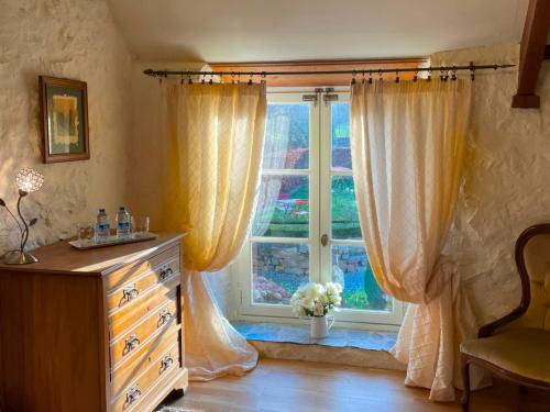 a bedroom with a dresser and a window at La Lande in Bricquebec