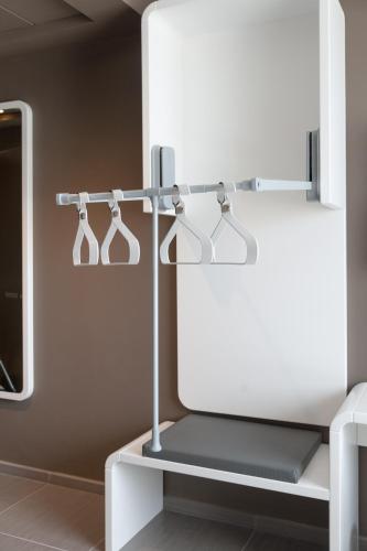 a row of four lights on a rack in a room at 8Piuhotel in Lecce