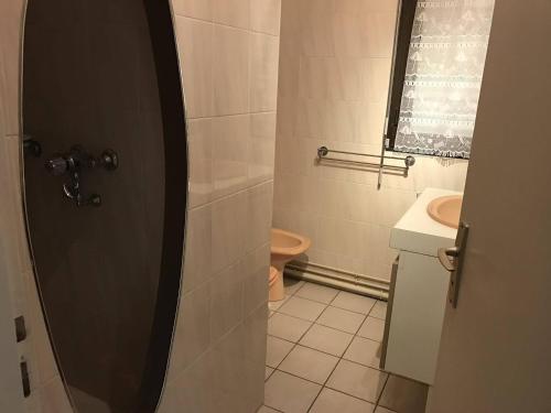 a bathroom with a toilet and a sink at Appartement Royan, 2 pièces, 4 personnes - FR-1-494-89 in Royan