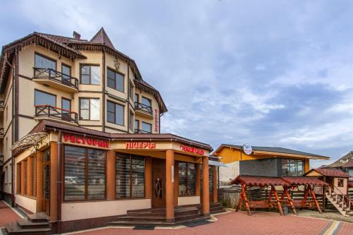 a building with a restaurant in front of it at Villa Vlad & Spa in Bukovel