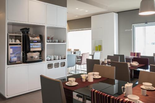 a dining room with a table and chairs at 8Piuhotel in Lecce