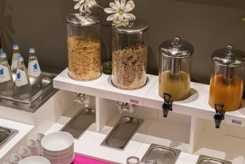 a kitchen counter with three jars of food at 8Piuhotel in Lecce