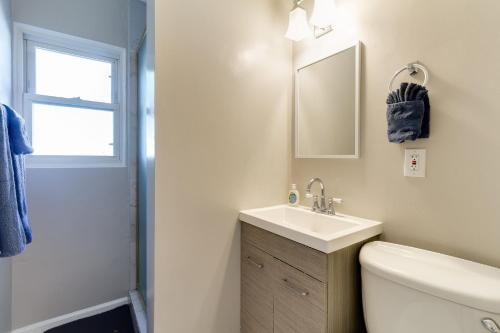 a bathroom with a sink and a toilet and a mirror at 4 bedroom house with a pool in Reseda