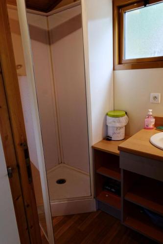 a bathroom with a shower and a sink at Chalet in Soursac