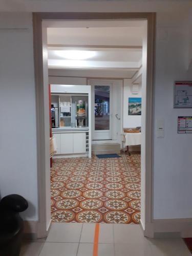 a hallway with a door leading to a kitchen at Logis Hôtel Restaurant Résidence in Nissan-lez-Enserune