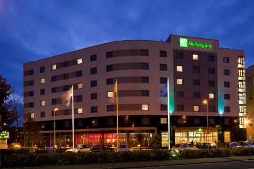a large building with a sign on top of it at Holiday Inn Norwich City by IHG in Norwich