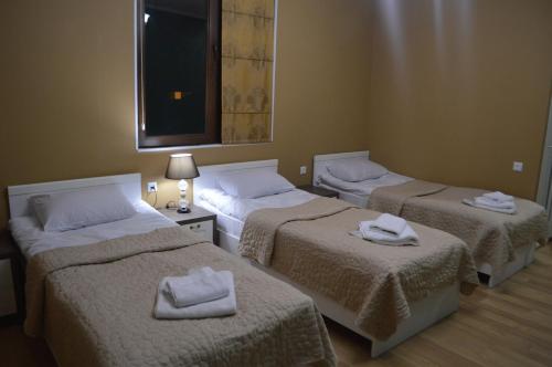 three beds in a room with towels on them at Renaissance Hotel Tbilisi in Tbilisi City