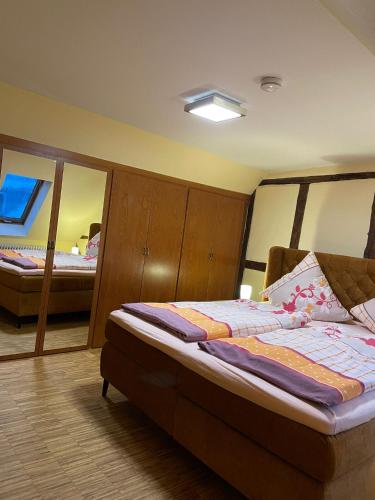 a bedroom with a bed with wooden wardrobes and a bed sidx sidx sidx at Altstadtwohnung Kromers & Restaurant in Erfurt