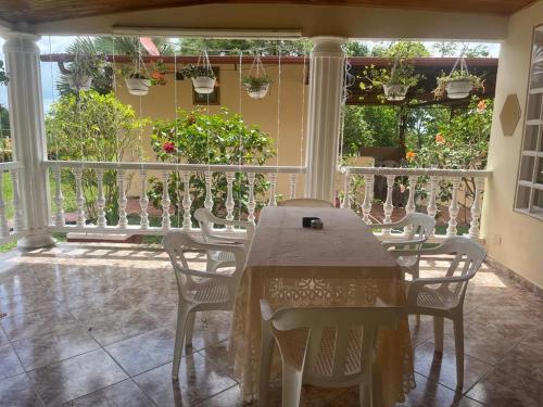 a table and chairs in a room with a balcony at EL ANHELO in Cumaral