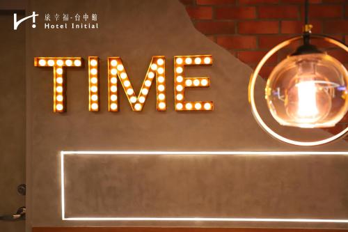 a neon sign for a hotel with a light at Hotel Initial-Taichung in Taichung
