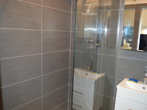 une salle de bain avec une douche avec un lavabo et un miroir dans l'établissement Studio rénové climatisé, 3 couchages, proche port et casino à Cavalaire-sur-Mer - FR-1-226B-98, à Cavalaire-sur-Mer