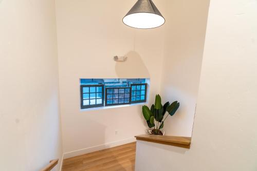 a room with a window and a potted plant at Luxury 4-bed home in Riverside Heights! in Reno