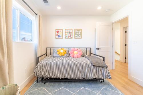 a bedroom with a bed with pillows and a window at Luxury 4-bed home in Riverside Heights! in Reno