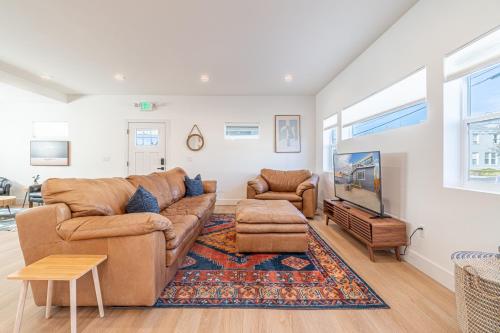 a living room with a couch and a tv at Luxury 4-bed home in Riverside Heights! in Reno