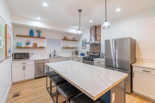 a kitchen with a table and a refrigerator at Luxury 4-bed home in Riverside Heights! in Reno