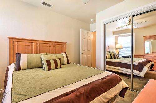 a bedroom with a large bed and a mirror at Waterfront Corpus Christi Townhome with Pool and Dock! in Corpus Christi