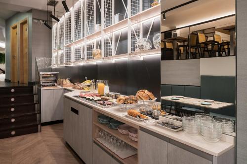 a kitchen with a counter with food on it at Hotel Mar del Plata in A Coruña