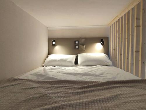 ein Schlafzimmer mit einem großen Bett mit zwei Kissen in der Unterkunft Appartement Cauterets, 2 pièces, 4 personnes - FR-1-234-271 in Cauterets