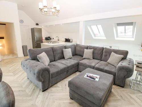a living room with a couch and a table at The Penthouse in York