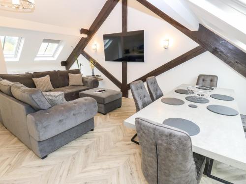 a living room with a table and a couch at The Penthouse in York