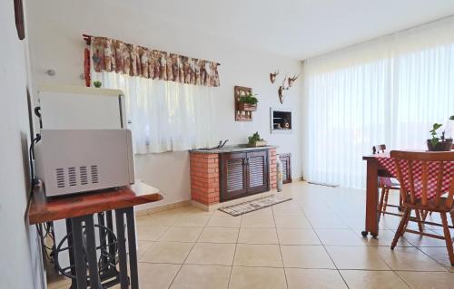 a living room with a table with a laptop on a table at Hospedaria Hartmann Haus in Treze Tílias