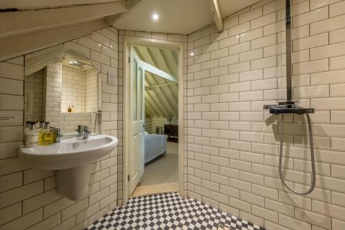 a bathroom with a sink and a shower at The Dairy at Green Valley Farm in Laxfield