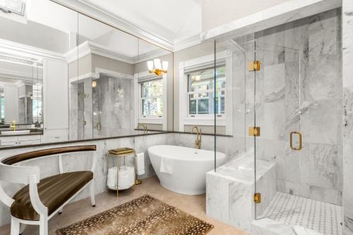 a bathroom with a tub and a sink at West End Splendor by Snowmass Vacations in Aspen